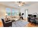 Bright living room with hardwood floors, ceiling fan, large windows, and an adjacent office space at 733 Frederica Ne St # 12, Atlanta, GA 30306