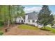 View of the home's backyard featuring a deck, lush lawn, and mature trees providing shade and privacy at 740 Trillium Ln, Lilburn, GA 30047