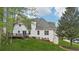 View of the home's backyard featuring a deck, lush lawn, and mature trees providing shade and privacy at 740 Trillium Ln, Lilburn, GA 30047