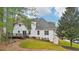 View of the home's backyard featuring a deck, lush lawn, and mature trees providing shade and privacy at 740 Trillium Ln, Lilburn, GA 30047