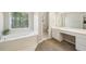 Bright bathroom with soaking tub under a window and a separate vanity area at 740 Trillium Ln, Lilburn, GA 30047