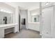 Large bathroom with vanity and makeup area adjacent to a shower at 740 Trillium Ln, Lilburn, GA 30047