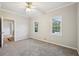 Bedroom featuring plush gray carpet, large windows, and stylish ceiling fan with light fixture at 740 Trillium Ln, Lilburn, GA 30047