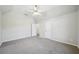 Bedroom featuring plush gray carpet, with 2 large doors and stylish ceiling fan with light fixture at 740 Trillium Ln, Lilburn, GA 30047