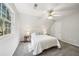 Cozy bedroom with plush gray carpet, window, and stylish ceiling fan with light fixture at 740 Trillium Ln, Lilburn, GA 30047