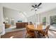Open dining area with wood floors, adjacent to the kitchen and living room, filled with lots of natural light at 740 Trillium Ln, Lilburn, GA 30047