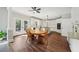 Open dining area with wood floors and white trim, flowing to the kitchen and featuring outdoor access at 740 Trillium Ln, Lilburn, GA 30047