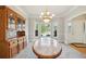 Traditional dining room featuring a bay window, a grand chandelier, and built in cabinet with wood finish at 740 Trillium Ln, Lilburn, GA 30047