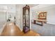 Hallway with hardwood floors leading to the dining room with a grandfather clock as a feature at 740 Trillium Ln, Lilburn, GA 30047