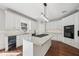 Well-lit kitchen with an island cooktop, granite counters, white cabinets, and stainless steel appliances at 740 Trillium Ln, Lilburn, GA 30047