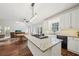 Modern kitchen island features a gas range with barstool seating and an open view into the rest of the house at 740 Trillium Ln, Lilburn, GA 30047