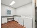 Convenient laundry room featuring washer, dryer and built-in desk at 740 Trillium Ln, Lilburn, GA 30047