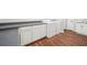 Laundry room showcasing a countertop, white cabinets and vinyl flooring at 740 Trillium Ln, Lilburn, GA 30047