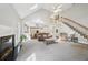Bright living room featuring vaulted ceilings, a fireplace, and an open floor plan leading to the kitchen at 740 Trillium Ln, Lilburn, GA 30047