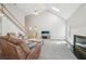 Inviting living room features comfortable reclining furniture, a fireplace, and vaulted ceilings at 740 Trillium Ln, Lilburn, GA 30047