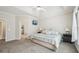 Spacious primary bedroom features a tray ceiling, carpet flooring and neutral colors at 740 Trillium Ln, Lilburn, GA 30047