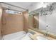 Cozy bathroom featuring a shower-tub combo, beige tile, and vanity sink at 1643 Wade Ne Ave, Atlanta, GA 30317