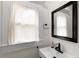 Bathroom with a rectangular sink, modern faucet, and framed mirror at 1643 Wade Ne Ave, Atlanta, GA 30317