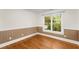 This bedroom features hardwood floors and a window view of the backyard at 1643 Wade Ne Ave, Atlanta, GA 30317
