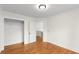 Bright bedroom with hardwood floors, white trim, open closet and access to the hallway at 1643 Wade Ne Ave, Atlanta, GA 30317