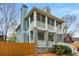Two-story home with screened porches, stone accents, chimney and wood fence in a leafy setting at 1643 Wade Ne Ave, Atlanta, GA 30317