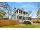 Two-story home with screened porches, stone accents, a tall chimney and fenced yard at 1643 Wade Ne Ave, Atlanta, GA 30317