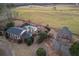 Aerial view showcasing a home, red barn, in-ground pool, and expansive pasture at 1909 Hickory Level Rd, Villa Rica, GA 30180