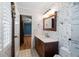 Stylish bathroom featuring unique wallpaper, a modern vanity, and an adjacent room view at 1909 Hickory Level Rd, Villa Rica, GA 30180