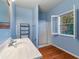 Bathroom featuring single sink vanity, framed mirror, walk-in shower and shuttered window views at 1909 Hickory Level Rd, Villa Rica, GA 30180