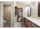 Bathroom with tile floors, double sink vanity with storage, and a decorative mirror at 1909 Hickory Level Rd, Villa Rica, GA 30180