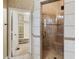 Bathroom with tile floors, a glass enclosed shower with seat, and a view of a walk-in closet at 1909 Hickory Level Rd, Villa Rica, GA 30180