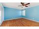 Light and airy bedroom featuring hardwood floors and bright blue walls at 1909 Hickory Level Rd, Villa Rica, GA 30180