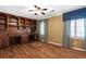 Spacious bedroom featuring hardwood floors, custom built-in shelves and cabinetry, and large windows at 1909 Hickory Level Rd, Villa Rica, GA 30180