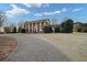 Grand brick home with stately white columns and a long, elegant driveway at 1909 Hickory Level Rd, Villa Rica, GA 30180