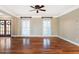 Bright living room features hardwood floors, crown molding, plantation shutters and a ceiling fan at 1909 Hickory Level Rd, Villa Rica, GA 30180