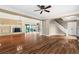 Spacious living room features hardwood floors, fireplace, stairs to the second floor and views of the sunroom at 1909 Hickory Level Rd, Villa Rica, GA 30180