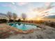 Relaxing pool with a tranquil sunset view, perfect for enjoying the evening at 1909 Hickory Level Rd, Villa Rica, GA 30180