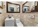 Charming powder room with patterned wallpaper, tiled floors, and framed mirrors at 1909 Hickory Level Rd, Villa Rica, GA 30180