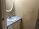 Cozy bathroom featuring a blue countertop and white round mirror at 2834 Royal Path Ct, Decatur, GA 30030