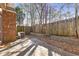 Brick house with concrete backyard and wooden fence, perfect for outdoor relaxation at 2930 Smith Ridge Trce, Peachtree Corners, GA 30071