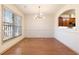 Dining area with hardwood floors, a modern chandelier, and an open view to the kitchen at 2930 Smith Ridge Trce, Peachtree Corners, GA 30071