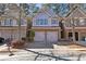 Charming townhome with brick and siding exterior, two-car garage, and well-maintained landscaping at 2930 Smith Ridge Trce, Peachtree Corners, GA 30071