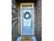 Inviting front door with wreath and 'home sweet home' doormat, set in brick surround at 2930 Smith Ridge Trce, Peachtree Corners, GA 30071