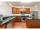 Well-lit kitchen features stainless steel appliances, an island and dark granite countertops at 2930 Smith Ridge Trce, Peachtree Corners, GA 30071