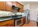 Kitchen features stainless steel appliances and dark granite countertops with hardwood floors at 2930 Smith Ridge Trce, Peachtree Corners, GA 30071