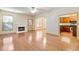 Bright living room with fireplace, hardwood floors, and view to the kitchen at 2930 Smith Ridge Trce, Peachtree Corners, GA 30071