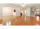 Open living space with hardwood floors, staircase, and open view to dining and kitchen at 2930 Smith Ridge Trce, Peachtree Corners, GA 30071