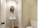 Charming powder room features a pedestal sink and modern fixtures at 2930 Smith Ridge Trce, Peachtree Corners, GA 30071