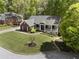 Aerial view of home, showcasing its manicured lawn, attractive landscaping, and inviting porch at 3100 Templeton Ln, Loganville, GA 30052