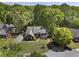 Aerial view of the home and the surrounding manicured lawn and mature tree landscaping at 3100 Templeton Ln, Loganville, GA 30052